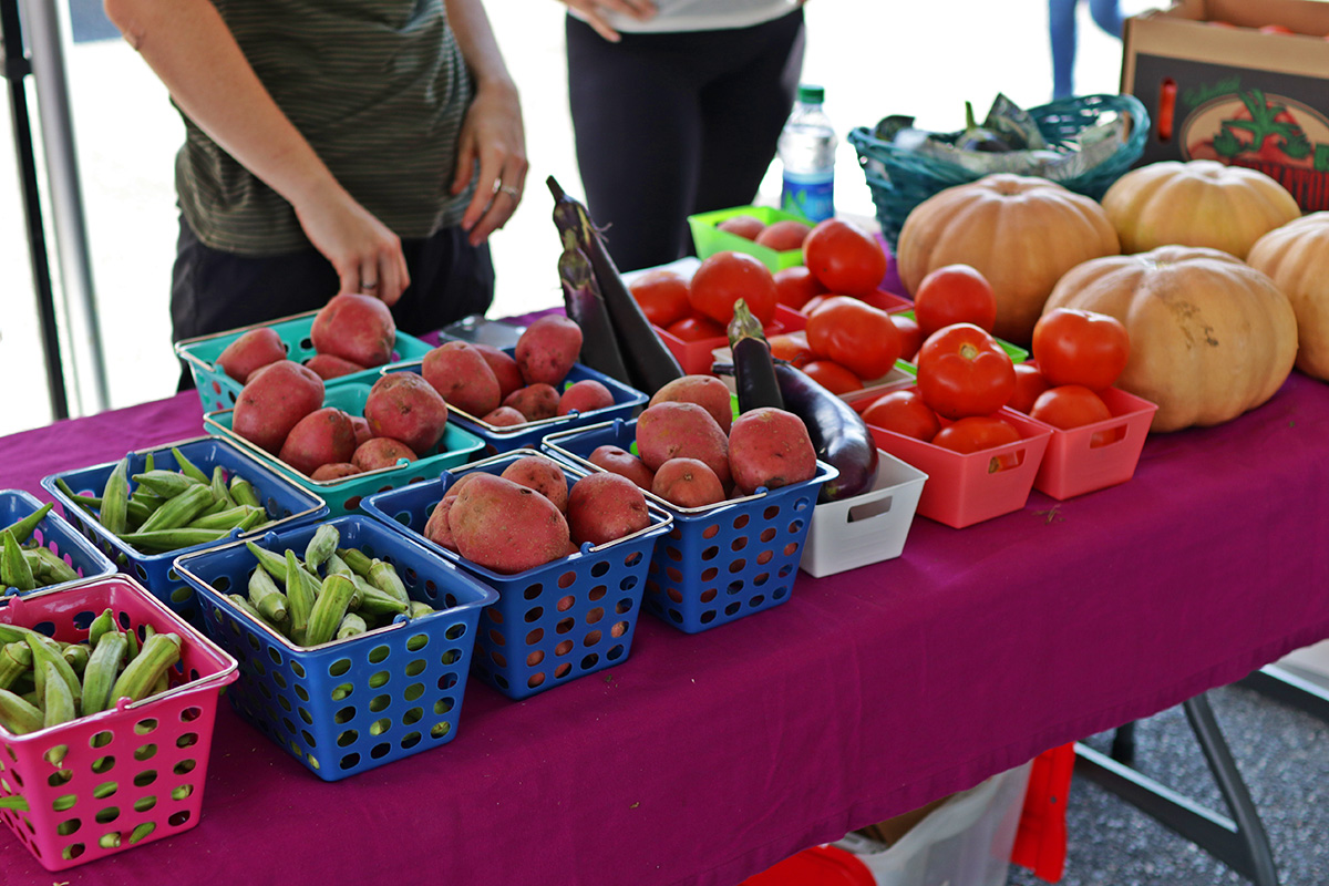 Tomatoes, okra, potatoes, and other fresh vegetables available.